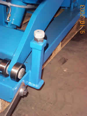 Baseframe of lift table showing adjustable downstops and arm roller bearings (Section 1)